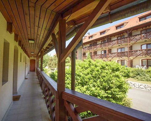 View of multiple balconies and landscaped pathway at Club Dobogomajor.