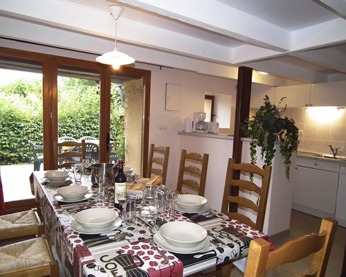 A well furnished dining area alongside the kitchen.