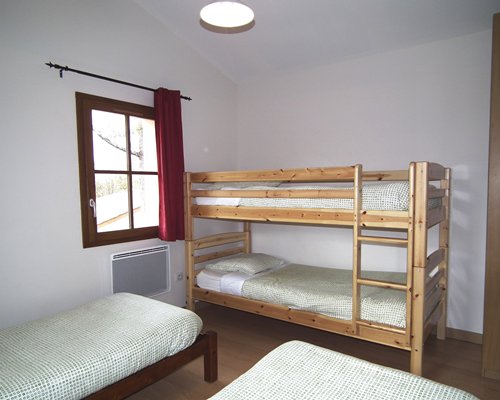 A bedroom with four twin beds.