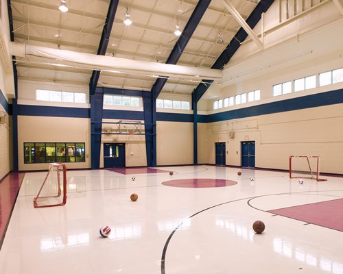 An indoor basketball court with a hockey setup.