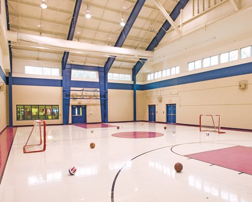 An indoor basketball court with hockey setup.