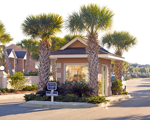 Street view of the resort units with palm trees.