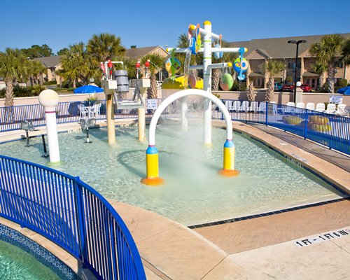 An outdoor kiddie pool with water sprinkles.