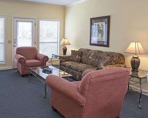 A well furnished living room with pull out sofa and an outside view.