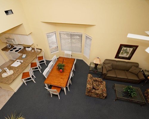 An open plan living dining and kitchen area with breakfast bar.