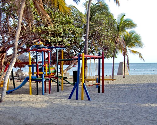 An outdoor playscape surrounded by trees.