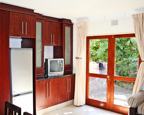 A well furnished living room with a television and patio.