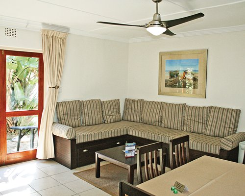 An open plan living and dining area with double pull out sofas and a patio.