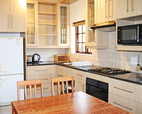 A well equipped kitchen with dining table.