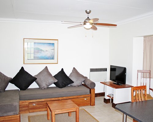 An open plan living and dining area with a television.