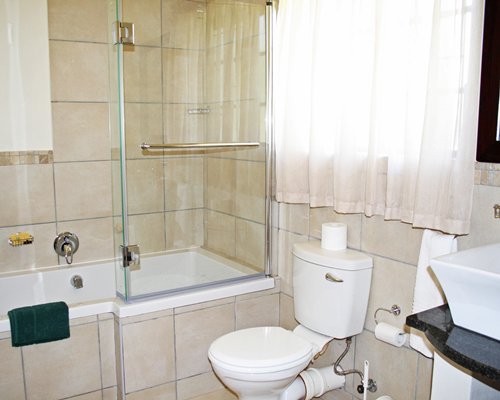 A bathroom with a bathtub and shower.