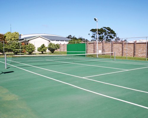 An outdoor tennis court alongside the resort.