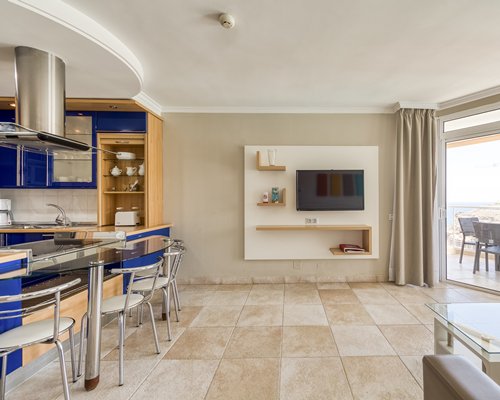 An open plan living and dining area alongside kitchen.