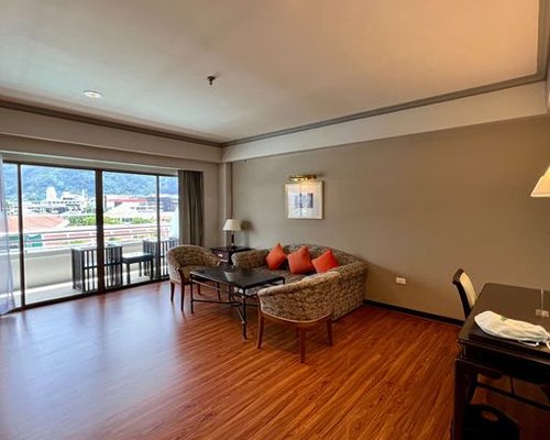 A well furnished bedroom with twin beds and a balcony.