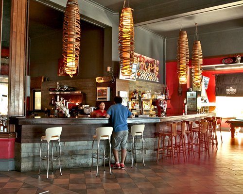 Indoor bar with a bar counter at Gran Hotel Pucon.