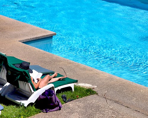 Outdoor swimming pool with chaise lounge chairs.