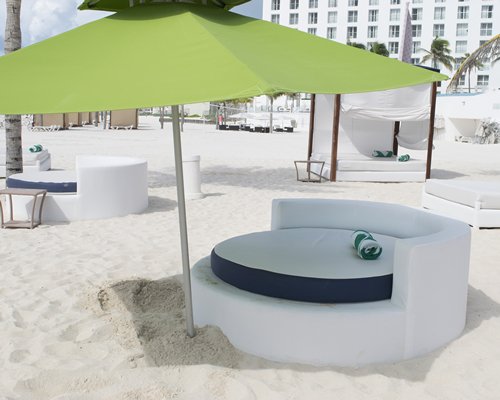 An outdoor lounge area with sunshades on the beach.