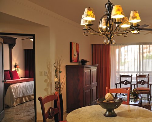 A well furnished dining room alongside a bedroom.