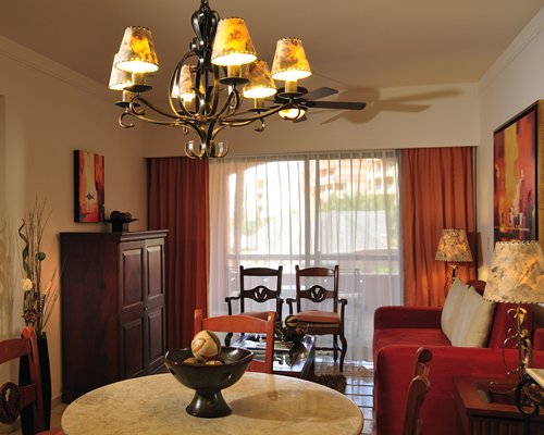 An open plan living and dining area with a pull out sofa.