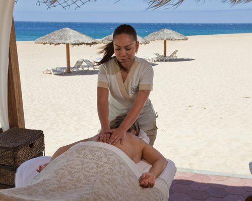 A man enjoying a massage alongside the beach.