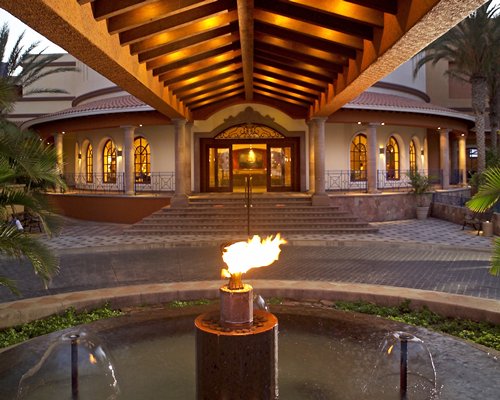 A view of the resort entrance alongside a torch with fire.