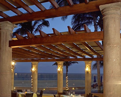 An outdoor fine dining restaurant alongside the ocean.