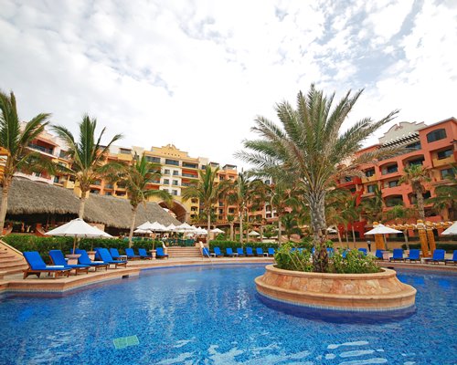 An outdoor swimming pool with chaise lounge chairs.