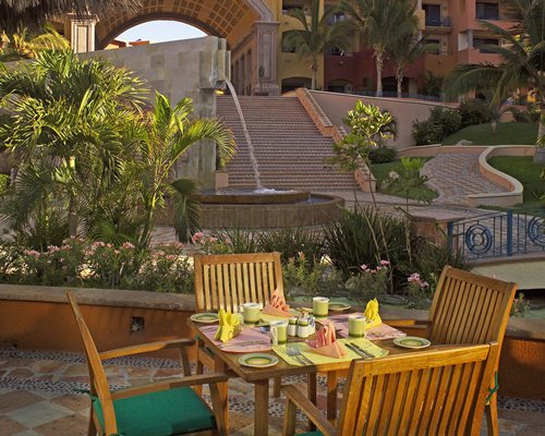 An outdoor fine dining restaurant alongside a water feature.