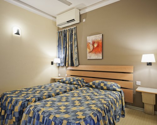 A well furnished bedroom with twin beds.