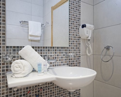 A bathroom with single sink vanity.