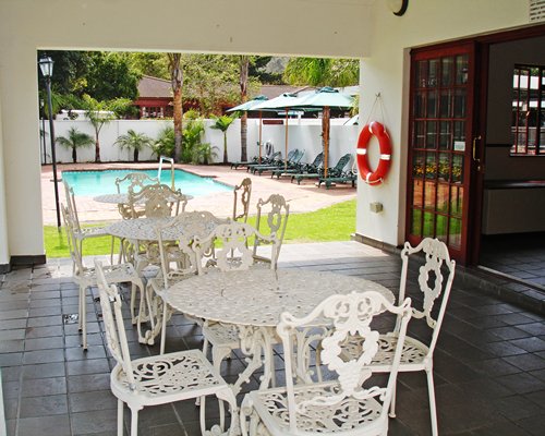 An outdoor patio alongside the swimming pool.