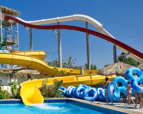 An outdoor swimming pool with the water slide.