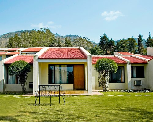 Scenic exterior view of a unit at Country Inn surrounded by wooded area.