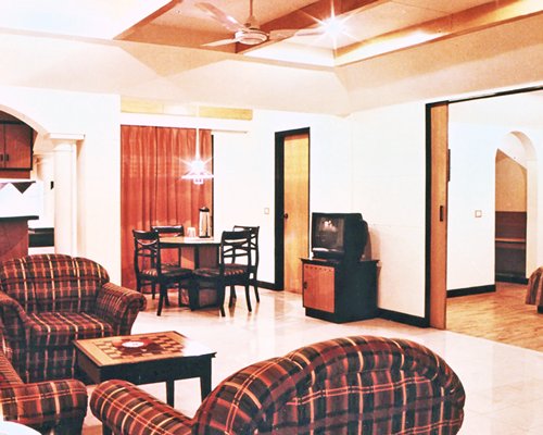 An open plan living and dining area with a television.