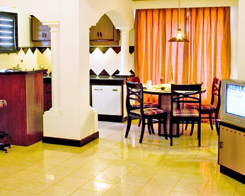 An open plan living and dining area with a television.