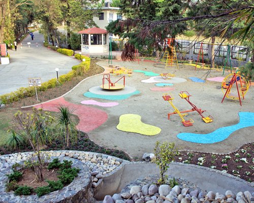 An outdoor play area surrounded by trees.
