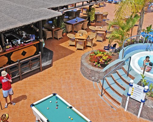 A view of an outdoor recreational area with a pool table.