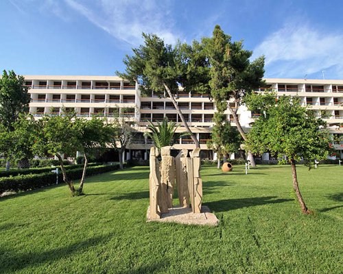 An exterior view of multi story resort units alongside trees.
