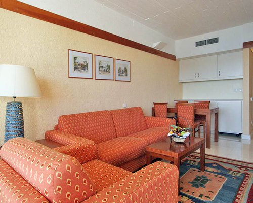 An open plan living and dining area with a double pull out sofa.
