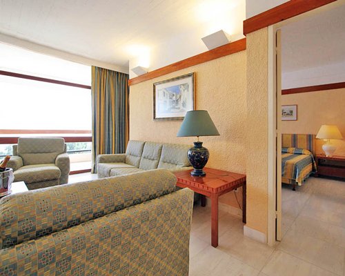 A well furnished living room with double pull out sofa and balcony.