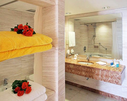 A bathroom with bathtub and single sink vanity.