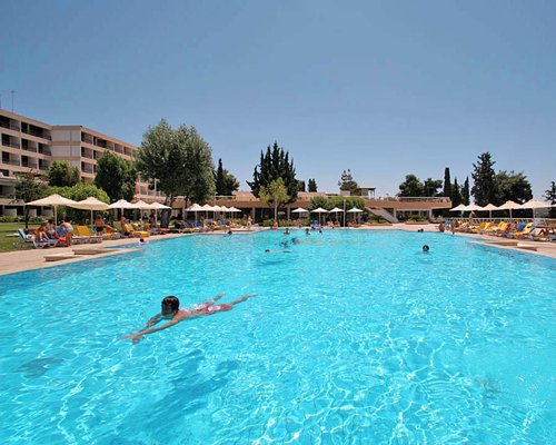 An outdoor swimming pool with chaise lounge chairs.