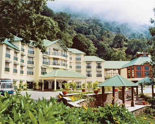 Scenic exterior view of the Club Mahindra Munnar resort surrounded by the wooded area.