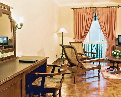 A well furnished living room with a television and balcony.