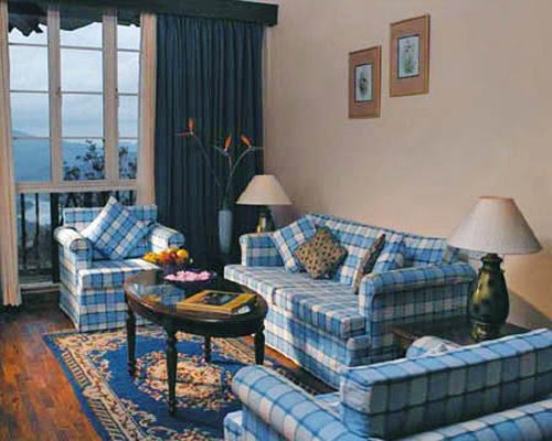 A well furnished living room with pull out sofas and a balcony.
