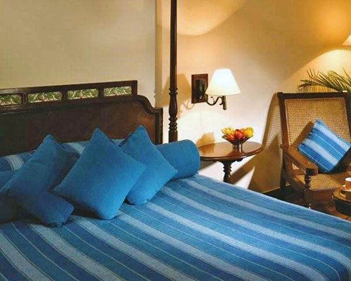 A well furnished bedroom with a chair.