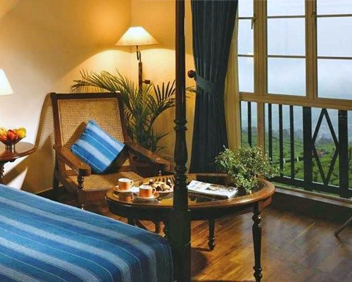 A well furnished bedroom with balcony and outside view.