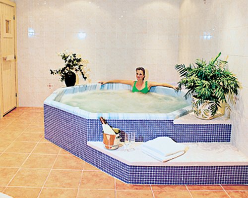 A woman in an indoor hot tub.
