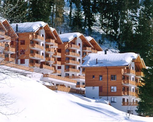 An exterior view of the multi story units in the snow.