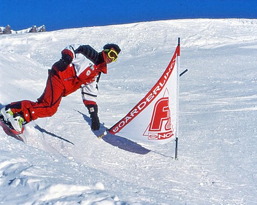 A man downhill skiing during winter.